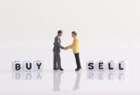 Two miniature businessman shaking hands on a stack of Euro money with ... How to Sell Personalized Gifts Internationally